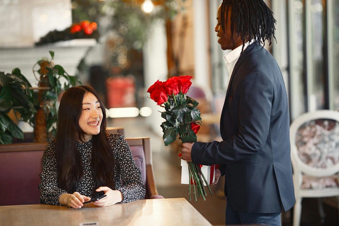Man giving woman flowers
